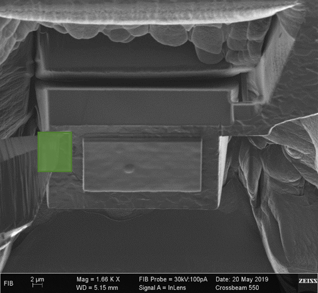 Figure 1. Ion beam micrograph showing the needle in position over the top corner opposite the bridge, with the green box indicating where to deposit the Pt/W