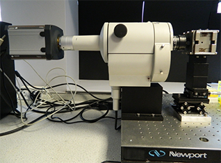 Set-up at Levy’s lab showing the Nikon AZ-100 lying horizontally with the Neo attached on one side and the custom designed NdFeB magnet on the other side.